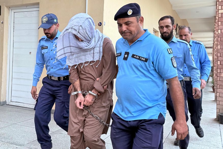 Police officers escorts a suspect Umar Hayat, second left, who allegedly killed a teenage social media influencer Sana Yousaf, following his court appearance in Islamabad, Pakistan, Thursday, Sept. 25, 2025. (AP Photo/Muhammad Yousuf)