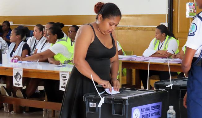 A woman casts her vote at English River School in Victoria, Seychelles, Thursday, Sept. 25, 2025. (AP Photo/Emilie Chetty)