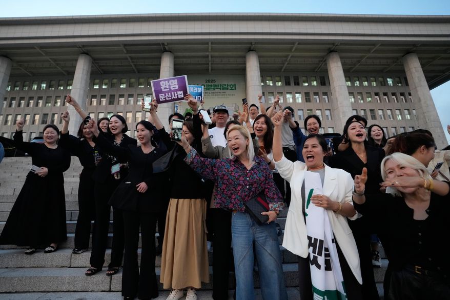 Members of the Korea Tattoo Federation react after hearing the news that parliament passed a bill that would allow non-medical personnel to give tattoos, outside the National Assembly in Seoul, South Korea, Thursday, Sept. 25, 2025, (AP Photo/Ahn Young-joon)