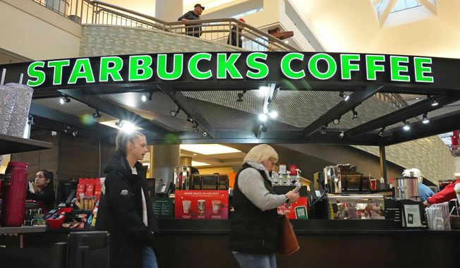 Shoppers at the Walden Galleria in Buffalo, NY, stop by the Starbucks kiosk on Saturday, Nov. 30, 2024. (AP Photo/Gene J. Puskar, File)