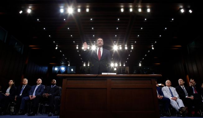 FILE - Former FBI Director James Comey is sworn in during a Senate Intelligence Committee hearing on Capitol Hill, June 8, 2017, in Washington. (AP Photo/Alex Brandon, File)