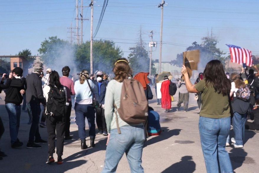 CAPTION CORRECTS LOCATION - Federal agents fired pepper balls and tear gas at protesters after some people tried to block a car from reaching a federal immigration enforcement building in Broadview, Ill. on Friday, Sept. 26, 2025. (AP Photo/Laura Bargfeld)
