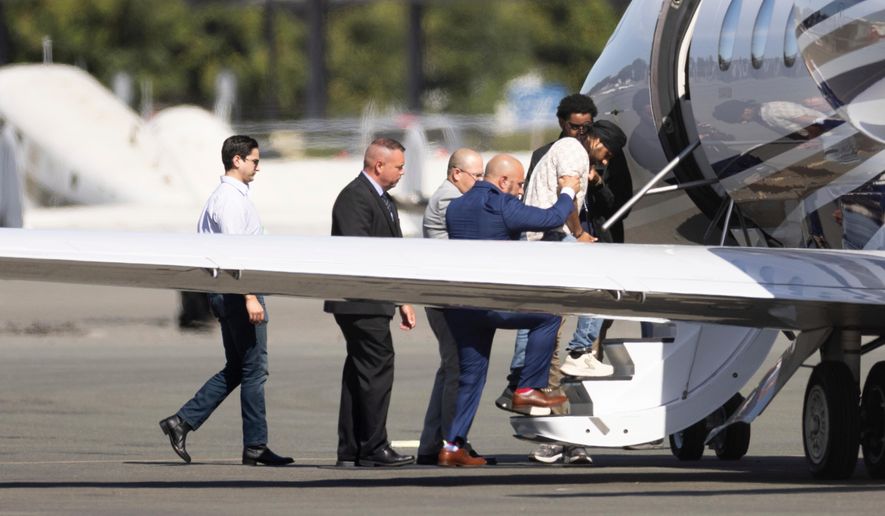 FILE - Harjinder Singh is escorted onto an airplane by Florida Lt. Gov. Jay Collins and law enforcement on Thursday, Aug. 21, 2025, in Stockton, Calif. (AP Photo/Benjamin Fanjoy, file)