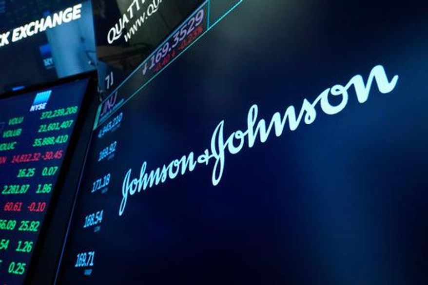 FILE - The Johnson & Johnson logo appears above a trading post on the floor of the New York Stock Exchange, Monday, July 12, 2021. (AP Photo/Richard Drew, File)