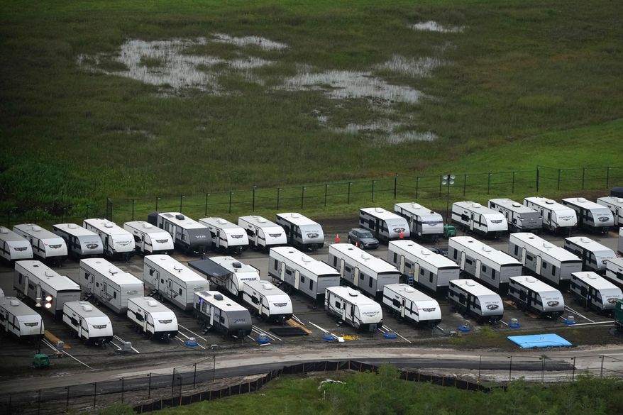 FILE - Trailers sit parked in lines as work progresses on a migrant detention center at Dade-Collier Training and Transition facility in the Florida Everglades, July 4, 2025, in Ochopee, Fla. (AP Photo/Rebecca Blackwell, file)