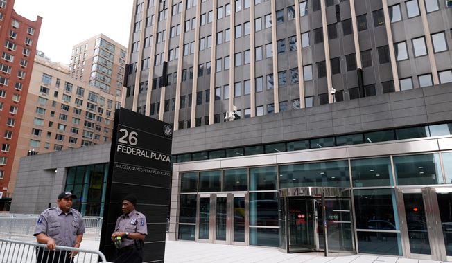 FILE - Security guards stand outside the Jacob K. Javits Federal Office Building at 26 Federal Plaza, Monday, Sept. 30, 2024, in New York. (AP Photo/Pamela Smith, file)