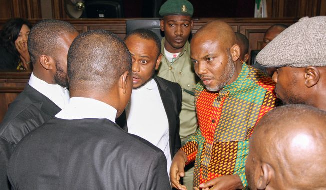FILE - Biafran separatist leader Nnamdi Kanu, center right, speaks with his lawyers at the Federal High Court in Abuja, Nigeria, on Jan 29, 2016. (AP Photo/File)