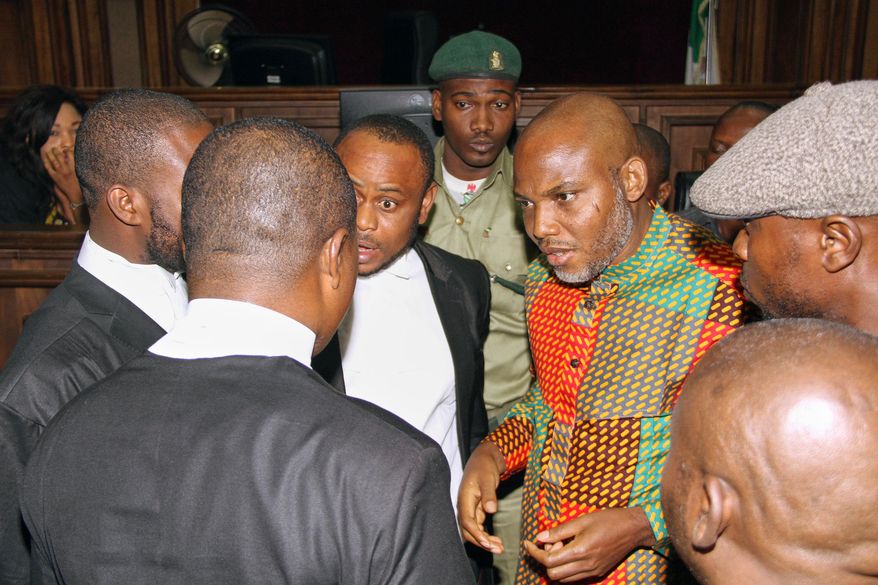 FILE - Biafran separatist leader Nnamdi Kanu, center right, speaks with his lawyers at the Federal High Court in Abuja, Nigeria, on Jan 29, 2016. (AP Photo/File)