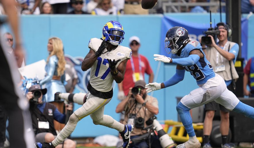Los Angeles Rams wide receiver Davante Adams, left, makes a touchdown catch as Tennessee Titans cornerback L'Jarius Sneed defends during the second half of an NFL football game Sunday, Sept. 14, 2025, in Nashville, Tenn. (AP Photo/George Walker IV)