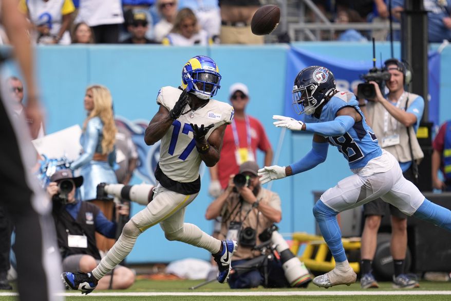 Los Angeles Rams wide receiver Davante Adams, left, makes a touchdown catch as Tennessee Titans cornerback L'Jarius Sneed defends during the second half of an NFL football game Sunday, Sept. 14, 2025, in Nashville, Tenn. (AP Photo/George Walker IV)