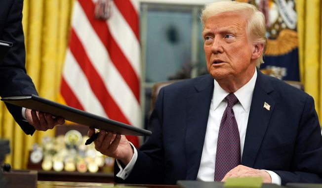 President Donald Trump signs executive orders in the Oval Office of the White House, Jan. 20, 2025, in Washington. (AP Photo/Evan Vucci, File)
