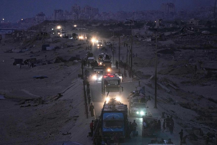 Displaced Palestinians flee northern Gaza, by vehicle and on foot, carrying their belongings along the coastal road near Wadi Gaza, Friday, Sept. 26, 2025. (AP Photo/Abdel Kareem Hana)