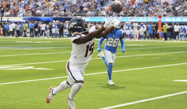 Denver Broncos wide receiver Marvin Mims Jr. (19) misses on a catch attempt during the first half an NFL football game against the Los Angeles Chargers, Sunday, Sept. 21, 2025, in Inglewood, Calif. (AP Photo/Gregory Bull)