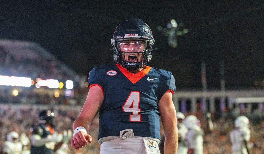 Virginia quarterback Chandler Morris (4) celebrates after a touchdown during the second half of an NCAA college football game, Friday, Sept. 26 2025, in Charlottesville, Va. (AP Photo/Robert Simmons)