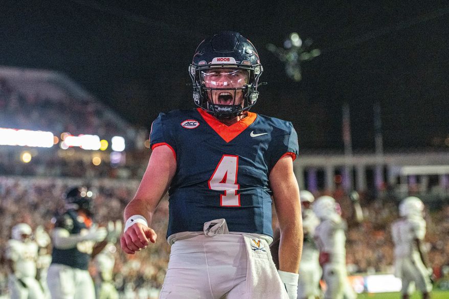 Virginia quarterback Chandler Morris (4) celebrates after a touchdown during the second half of an NCAA college football game, Friday, Sept. 26 2025, in Charlottesville, Va. (AP Photo/Robert Simmons)