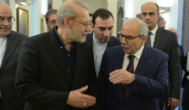 In this photo released by the Lebanese Government Press Office, Lebanese Prime Minister Nawaf Salam, right, speaks with Iranian Secretary of Supreme National Security Council Ali Larijani, at the government palace in Beirut, Lebanon, Saturday, Sept. 27, 205. (Lebanese Government Press Office via AP)