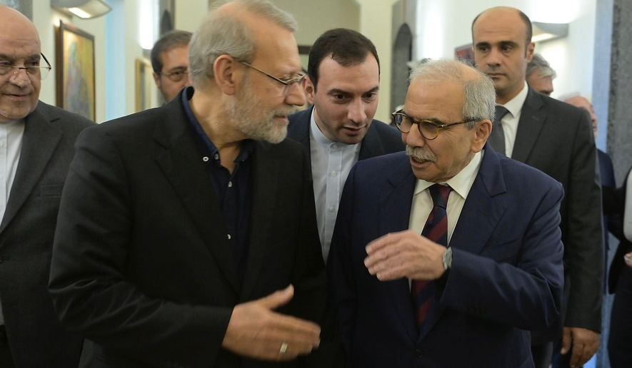 In this photo released by the Lebanese Government Press Office, Lebanese Prime Minister Nawaf Salam, right, speaks with Iranian Secretary of Supreme National Security Council Ali Larijani, at the government palace in Beirut, Lebanon, Saturday, Sept. 27, 205. (Lebanese Government Press Office via AP)