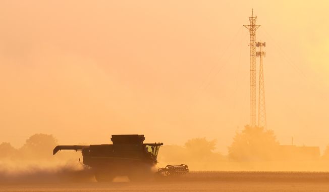 Soybeans are harvested on the Warpup Farm in Warren, Ind., Wednesday, Sept. 17, 2025. (AP Photo/Michael Conroy)