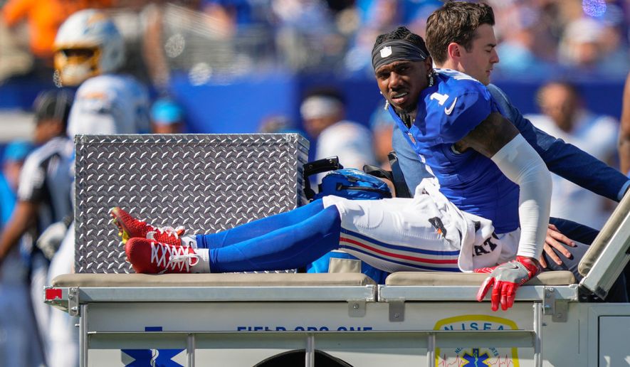 New York Giants wide receiver Malik Nabers (1) is driven off the field by medical personnel after an injury during the second quarter of an NFL football game against the Los Angeles Chargers, Sunday, Sept. 28, 2025, in East Rutherford, N.J. (AP Photo/Yuki Iwamura)