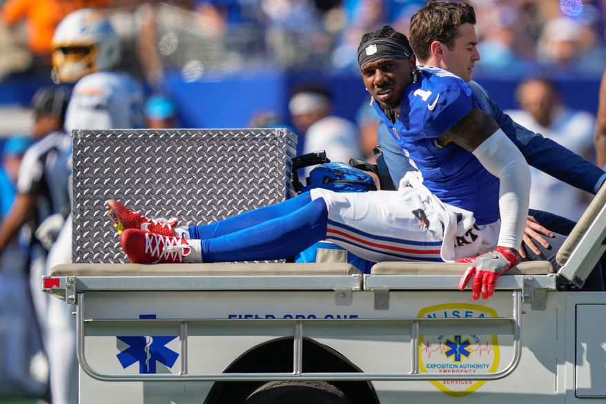 New York Giants wide receiver Malik Nabers (1) is driven off the field by medical personnel after an injury during the second quarter of an NFL football game against the Los Angeles Chargers, Sunday, Sept. 28, 2025, in East Rutherford, N.J. (AP Photo/Yuki Iwamura)