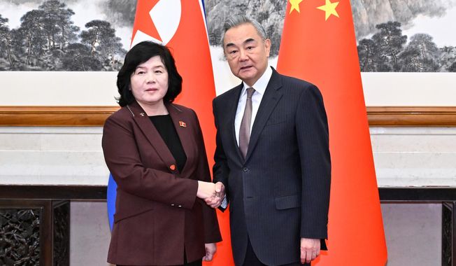 In this photo released by Xinhua News Agency, Chinese Foreign Minister Wang Yi, right, shakes hands with visiting North Korean counterpart Choe Son Hui prior to a meeting, in Beijing on Sunday, Sept. 28, 2025. (Yue Yuewei/Xinhua via AP)