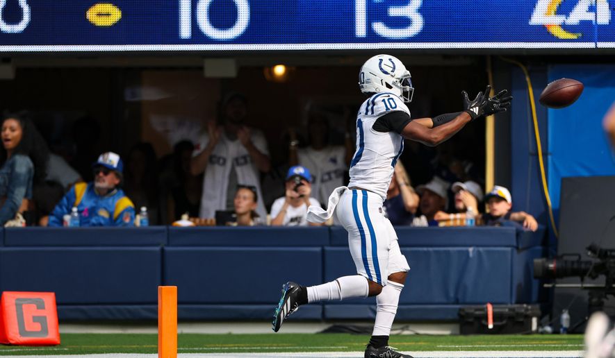 Indianapolis Colts wide receiver Adonai Mitchell (10) fumbles the ball before crossing the goal line against the Los Angeles Rams during the second hall of an NFL football game Sunday, Sept. 28, 2025, in Inglewood, Calif. (AP Photo/Eric Thayer)