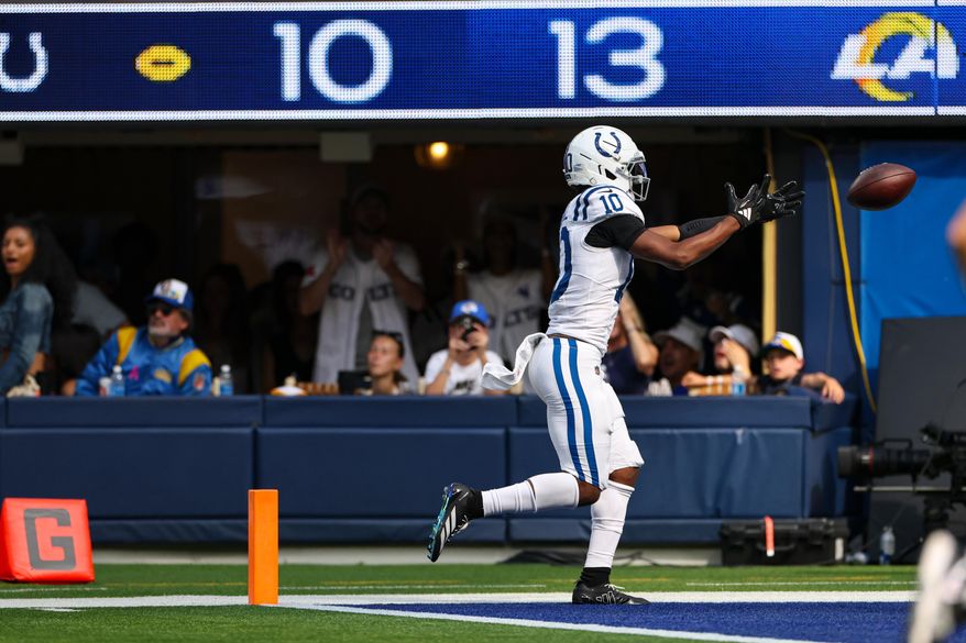 Indianapolis Colts wide receiver Adonai Mitchell (10) fumbles the ball before crossing the goal line against the Los Angeles Rams during the second hall of an NFL football game Sunday, Sept. 28, 2025, in Inglewood, Calif. (AP Photo/Eric Thayer)