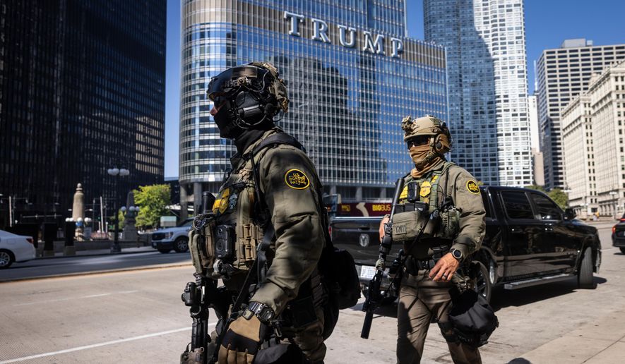 Federal agents from U.S. Immigration and Customs Enforcement and U.S. Customs and Border Protection walk along West Wacker Drive in the Loop, Sunday, Sept. 28, 2025, in Chicago. (Ashlee Rezin/Chicago Sun-Times via AP) ** FILE **