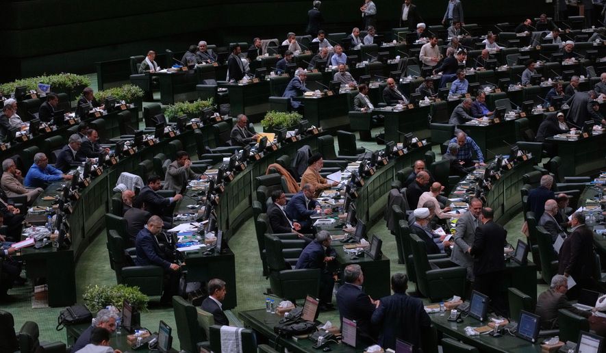 Iranian lawmakers attend an open session of parliament in Tehran, Iran, Sunday, Sept. 28, 2025. (AP Photo/Vahid Salemi)