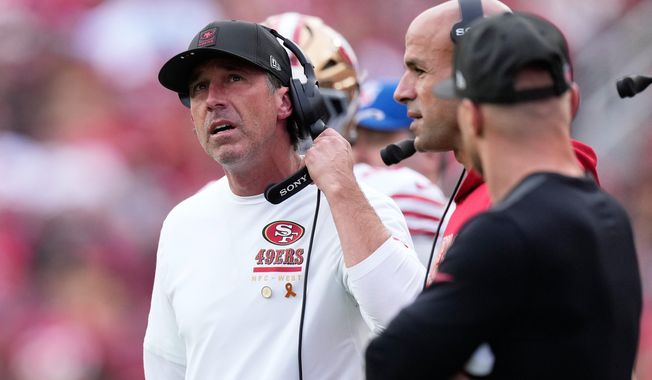 San Francisco 49ers head coach Kyle Shanahan, left, reacts next to defensive coordinator Robert Saleh, middle, during the first half of an NFL football game against the Jacksonville Jaguars in Santa Clara, Calif., Sunday, Sept. 28, 2025. (AP Photo/Godofredo A. Vásquez)