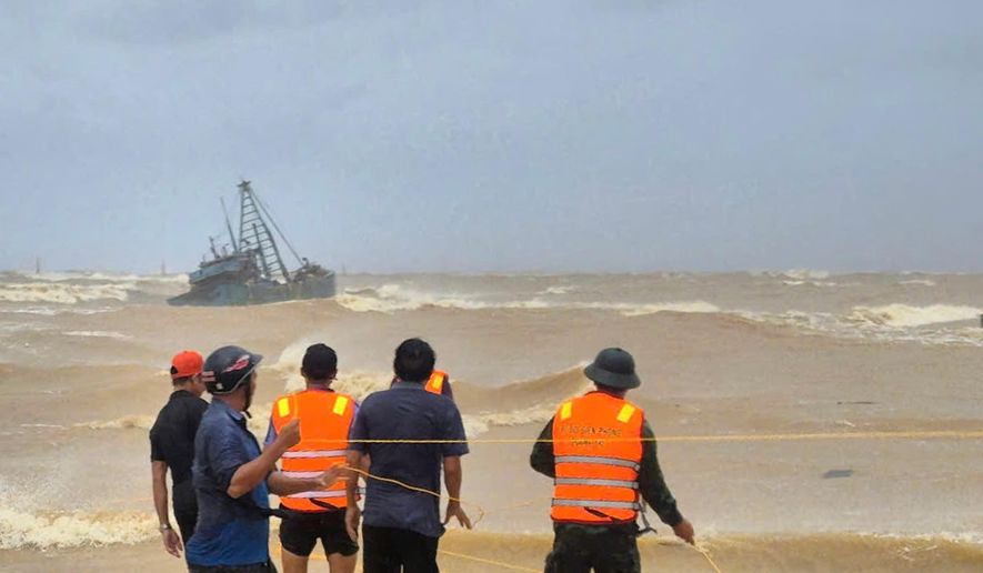 People work to rescue fishermen on a stranded fishing boat due to Typhoon Bualoi in Quang Tri, Vietnam Sunday, Sept. 28, 2025. (Trinh Quoc Dung/VNA via AP)