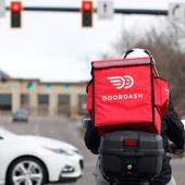 A food delivery rider waits for the traffic light to change in Lone Tree, Colo., on Monday, March 30, 2020. (AP Photo/David Zalubowski) **FILE**