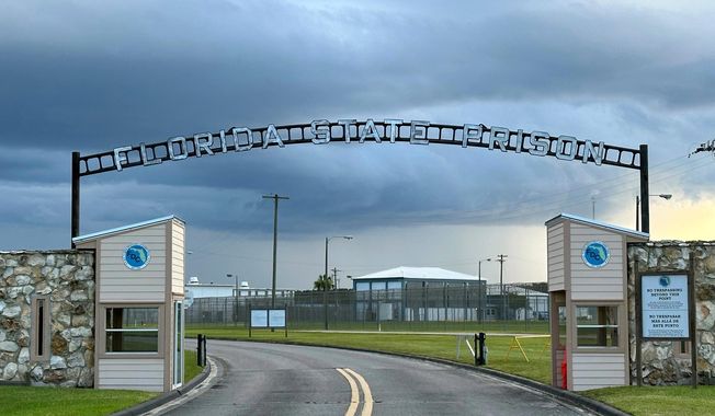 FILE - Clouds hover over the entrance of the Florida State Prison in Starke, Fla., Aug. 3, 2023. (AP Photo/Curt Anderson, file)