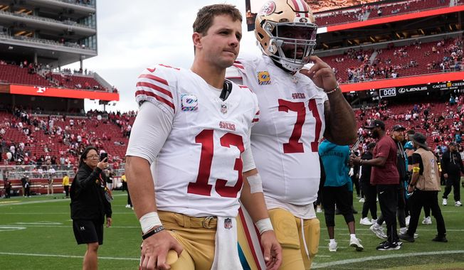 San Francisco 49ers quarterback Brock Purdy (13) and offensive tackle Trent Williams (71) walk off the field after an NFL football game against the Jacksonville Jaguars in Santa Clara, Calif., Sunday, Sept. 28, 2025. (AP Photo/Godofredo A. Vásquez)