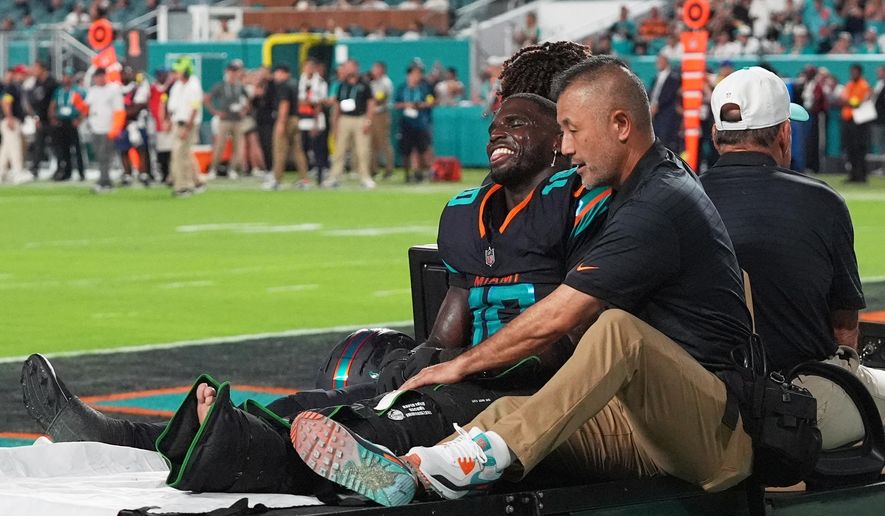 Miami Dolphins wide receiver Tyreek Hill (10) is carted off the field by staff after suffering an unknown injury in the second half of an NFL football game against the New York Jets, Monday, Sept. 29, 2025, in Miami Gardens, Fla. (AP Photo/Marta Lavandier) ** FILE **