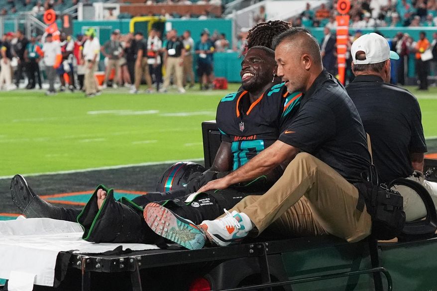 Miami Dolphins wide receiver Tyreek Hill (10) is carted off the field by staff after suffering an unknown injury in the second half of an NFL football game against the New York Jets, Monday, Sept. 29, 2025, in Miami Gardens, Fla. (AP Photo/Marta Lavandier) ** FILE **