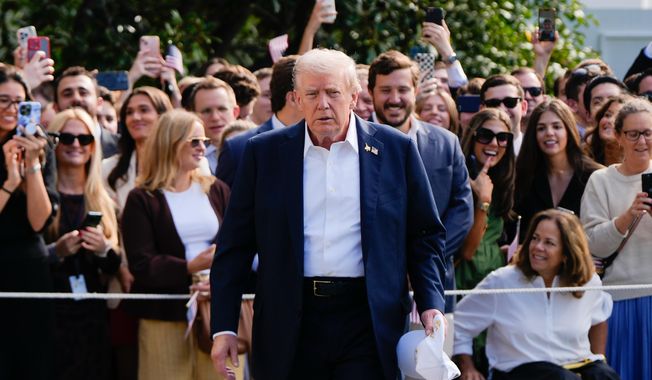 President Donald Trump walks to speak with reporters after greeting supporters before departing the White House, Friday, Sept. 26, 2025, in Washington. (AP Photo/Julia Demaree Nikhinson)