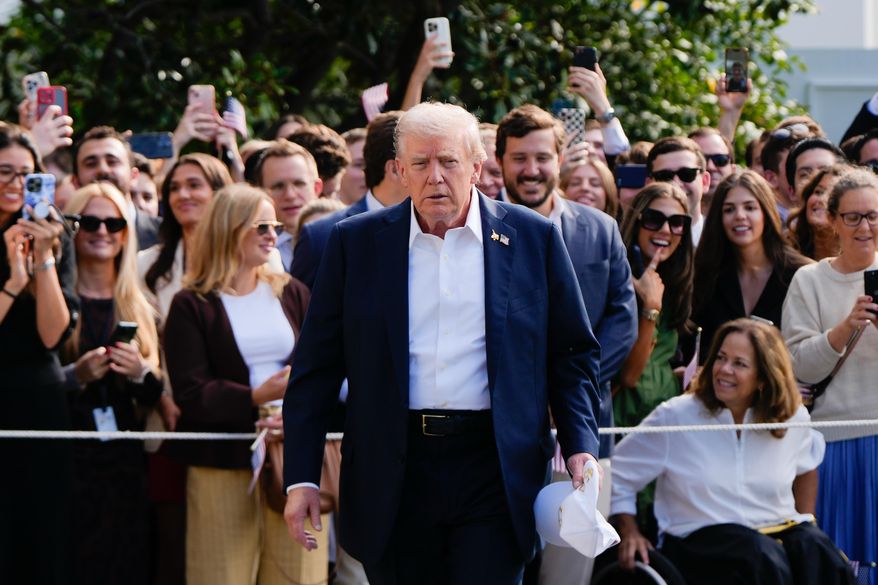 President Donald Trump walks to speak with reporters after greeting supporters before departing the White House, Friday, Sept. 26, 2025, in Washington. (AP Photo/Julia Demaree Nikhinson)