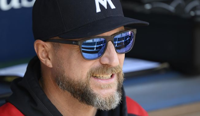 Minnesota Twins manager Rocco Baldelli talks to one of his players before a baseball game against the Kansas City Royals in Kansas City, Mo., Sunday, Sept. 7, 2025. (AP Photo/Reed Hoffmann)