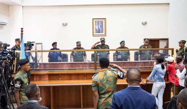 Military officers stand in the dock during the trial of former Congolese President Joseph Kabila in Kinshasa, Democratic Republic of Congo, Tuesday, Sept. 30, 2025 (AP Photo/ Samy Ntumba Shambuyi)