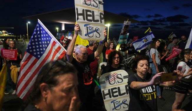 Relatives and supporters of hostages held by Hamas in the Gaza Strip calling for their immediate release and an end of the ongoing war, in front of the U.S. Embassy branch office in Tel Aviv, Israel, Monday, Sept. 29, 2025. (AP Photo/Ariel Schalit)