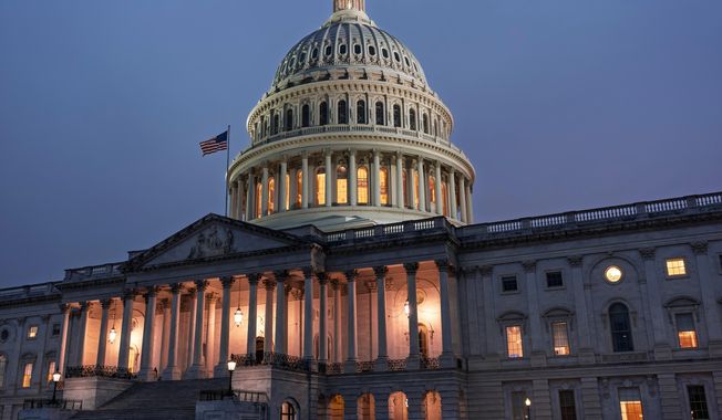 The Capitol is seen at dusk as Democrats and Republicans in Congress are angrily blaming each other and refusing to budge from their positions on funding the government, in Washington, Tuesday, Sept. 30, 2025. (AP Photo/J. Scott Applewhite)