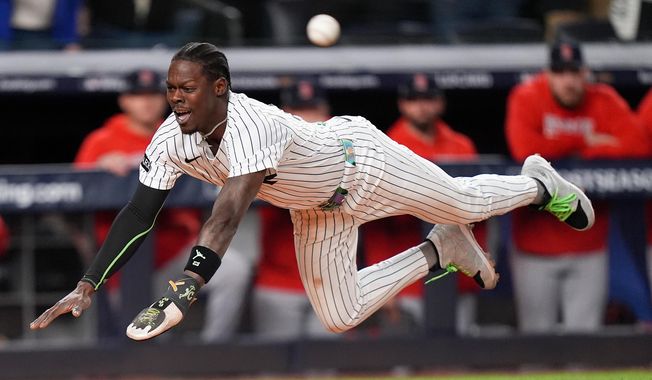 New York Yankees Jazz Chisholm Jr. dives into home plate to score on a hit by Austin Wells against the Boston Red Sox during the eighth inning of Game 2 of an American League wild-card baseball playoff series, Wednesday, Oct. 1, 2025, in New York. (AP Photo/Frank Franklin II)