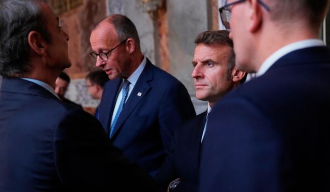 Germany's Chancellor Friedrich Merz and France's President Emmanuel Macron prior to an informal summit in the Danish parliament at Christiansborg Castle in Copenhagen, on Wednesday, Oct. 1, 2025. (Ida Marie Odgaard/Ritzau Scanpix via AP)