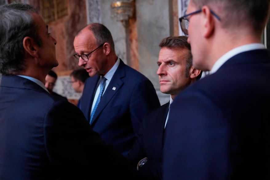 Germany's Chancellor Friedrich Merz and France's President Emmanuel Macron prior to an informal summit in the Danish parliament at Christiansborg Castle in Copenhagen, on Wednesday, Oct. 1, 2025. (Ida Marie Odgaard/Ritzau Scanpix via AP)
