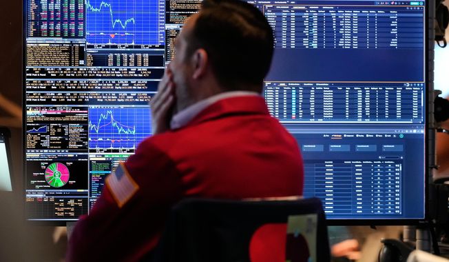 A trader looks at financial information on his computer on the floor at the New York Stock Exchange in New York, Wednesday, Oct. 1, 2025. (AP Photo/Seth Wenig)