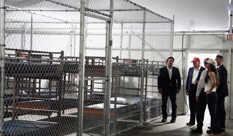 FILE - President Donald Trump, Gov. Ron DeSantis, R-Fla., and Homeland Security Secretary Kristi Noem, and others, tour "Alligator Alcatraz," a new migrant detention facility at Dade-Collier Training and Transition facility, Tuesday, July 1, 2025, in Ochopee, Fla. (AP Photo/Evan Vucci, File)