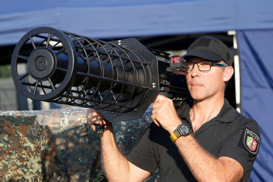 A police man demonstrates the new police drone defense unit on the occasion of the European Football Championship prior to the international friendly soccer match between Germany and Greece at the Borussia Park in Moenchengladbach, Germany, June 7, 2024. (AP Photo/Martin Meissner, File)