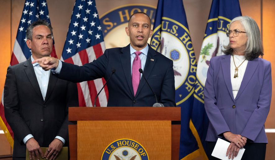 House Minority Leader Hakeem Jeffries, of N.Y., center, speaks as House Democratic Caucus Chairman Rep. Pete Aguilar, D-Calif., left, and House Minority Whip Rep. Katherine Clark, D-Mass., right, listen during a press conference on Capitol Hill on Wednesday, Oct. 1, 2025, in Washington. (AP Photo/Mark Schiefelbein)