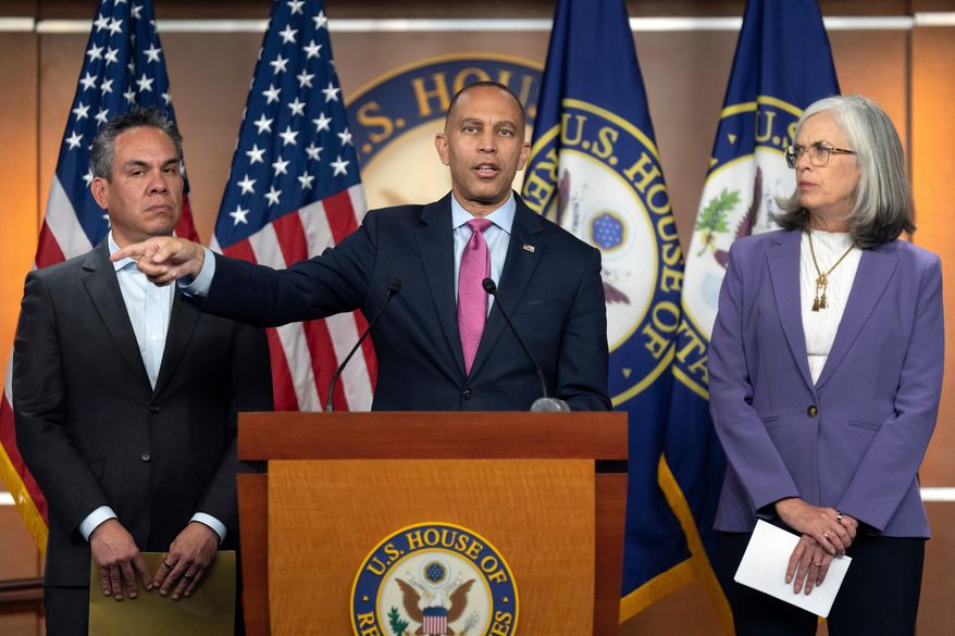House Minority Leader Hakeem Jeffries, of N.Y., center, speaks as House Democratic Caucus Chairman Rep. Pete Aguilar, D-Calif., left, and House Minority Whip Rep. Katherine Clark, D-Mass., right, listen during a press conference on Capitol Hill on Wednesday, Oct. 1, 2025, in Washington. (AP Photo/Mark Schiefelbein)